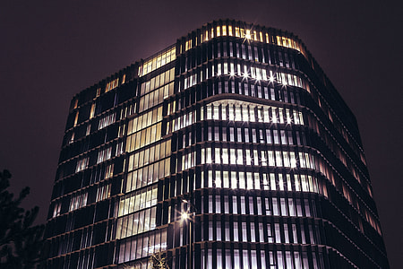 Office building at night with lights on thumbnail