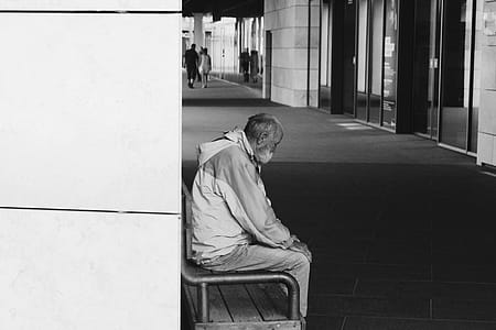 Grayscale Photography of Man Sitting on Chair thumbnail