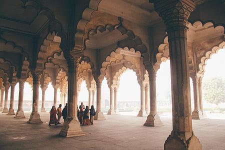 people gathered under concrete columns thumbnail