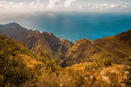bird's-eye view of mountain and body of water thumbnail