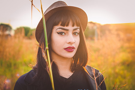 Portrait shot of a woman model wearing a hat in a field thumbnail
