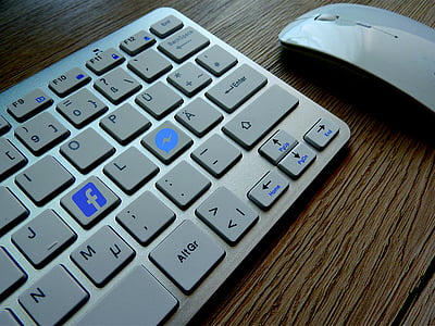 wireless computer keyboard and mouse on wood plank thumbnail