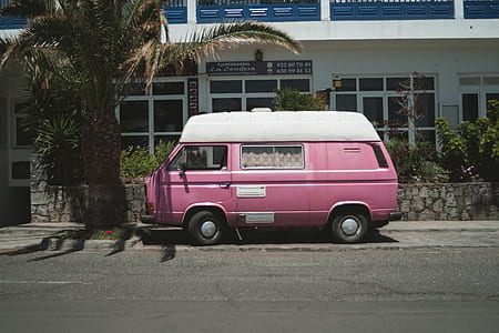 pink van parked near white house thumbnail
