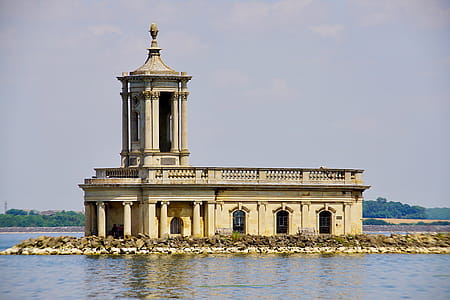Photo of White Concrete Building Near Body of Water thumbnail