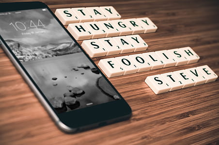 space gray iPhone 6 on wooden board beside scrabble letters thumbnail