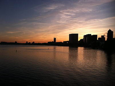 silhouette photo of body of water and building thumbnail
