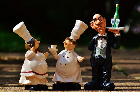 chef and waiter figurine on wooden surface thumbnail
