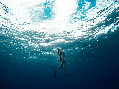 woman surfacing on water after diving underwater photography thumbnail