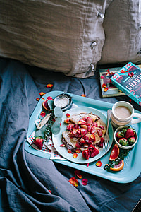 strawberries on teal ceramic plate near books thumbnail