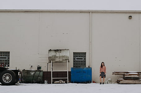 woman standing beside of blue container thumbnail