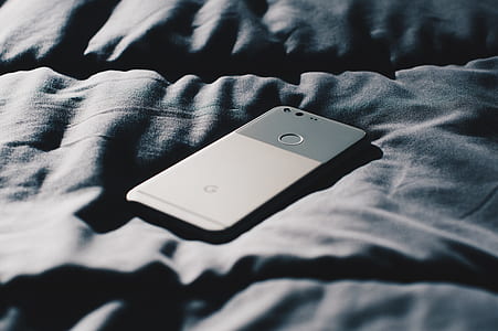 black Google Pixel smartphone on top of gray textile thumbnail