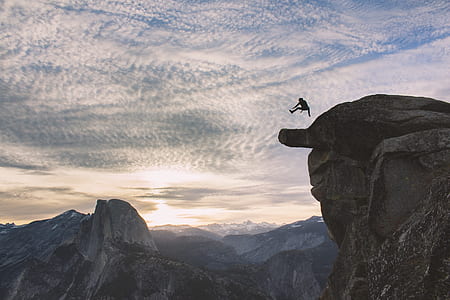 person jumping on rock cliff thumbnail