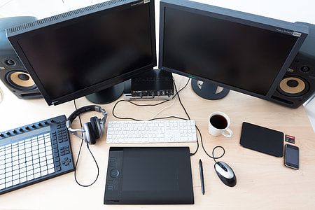 two black flat screen computer monitor on brown wooden table thumbnail