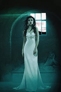woman wearing white spaghetti strap bodycon dress inside room thumbnail