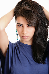 woman wearing blue top and teal dangling earrings thumbnail