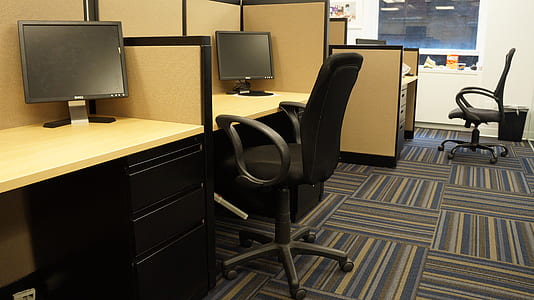 black rolling armchair in front of computer desk thumbnail