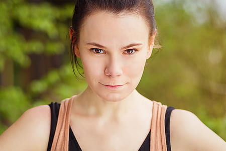 close-up photography of woman wearing brown and black tank top thumbnail