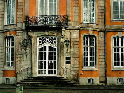 orange and brown concrete building with glass windows thumbnail