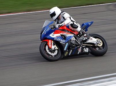 person riding blue sports bike on race track thumbnail