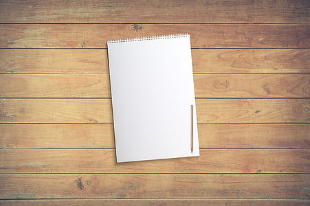 white notebook on brown wooden surface thumbnail