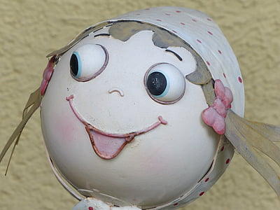 white ball with eyes ornament in close-up photo thumbnail