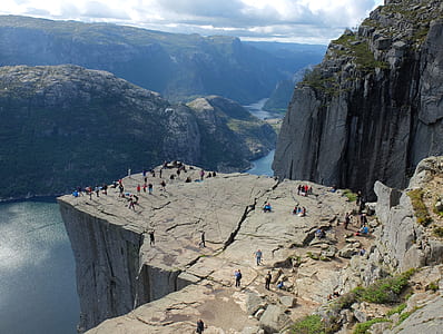 group of people standing on mountain during daytime thumbnail