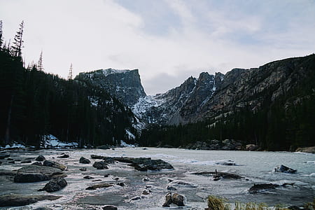 flowing river leading to mountain at daytime thumbnail