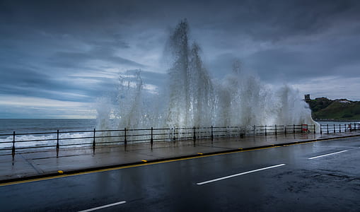 asphalt road near body of water thumbnail