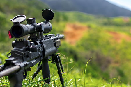 photo of black rifle with scope at daytime thumbnail