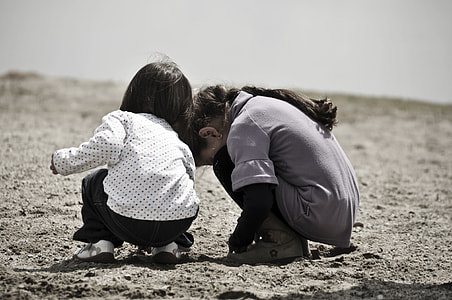 photo of two girl's in gray sand thumbnail