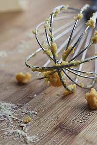 stainless steel whisk on brown board thumbnail