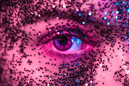 shallow focus photography of human eye surrounded by glitters thumbnail