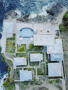 aerial view of mansion beside sea shore cliff thumbnail