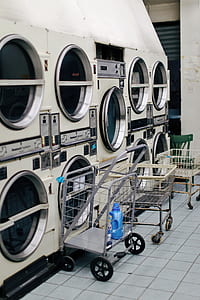 white metal carts near commercial front-load washers thumbnail
