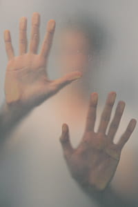 photo of person touching frosted glass thumbnail