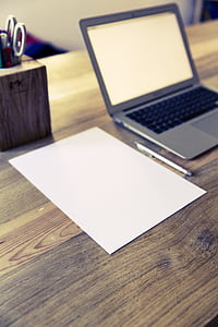 MacBook Air near on blank paper thumbnail