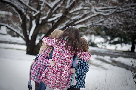 three girls on snowfield during daytime thumbnail