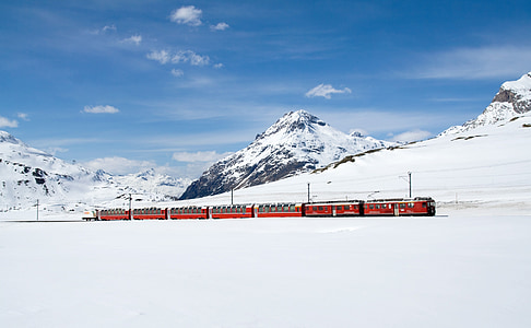 red and gray train during snow time thumbnail