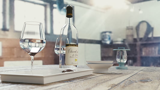 wine glass beside wine bottle on white tray thumbnail
