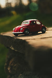 selective focus photography of red beetle car thumbnail