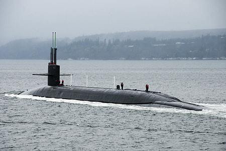 photo of black submarine under white clouds at daytime thumbnail
