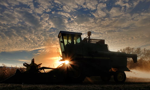 silhouette of farm tractor at the field thumbnail