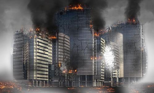 gray concrete building burning during daytime thumbnail