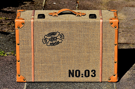 photo of brown suit case on brown concrete surface thumbnail