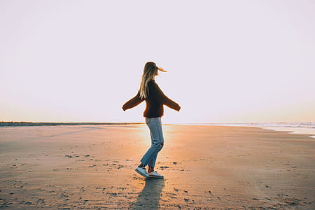 photography of woman standing on the beach thumbnail