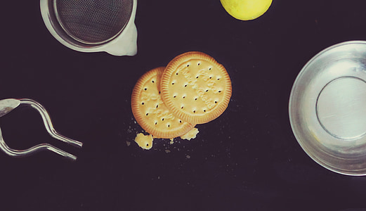 flat lay photography of biscuits beside mug and saucer thumbnail
