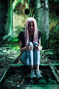 pink haired woman sitting on rail thumbnail