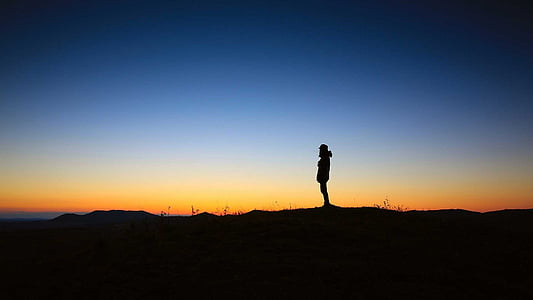 silhouette of person standing on the cliff thumbnail