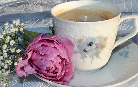 white floral ceramic cup filled near flower thumbnail