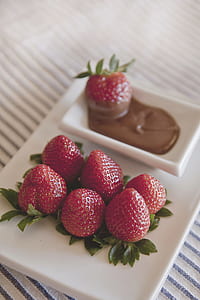 strawberry beside chocolate on white ceramic plate thumbnail